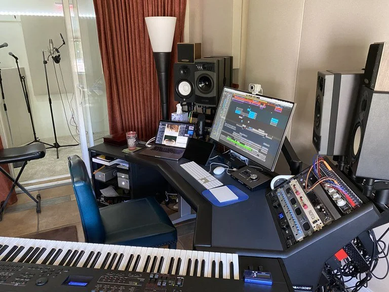 Control room — monitors, DAW, keyboards, and rack gear